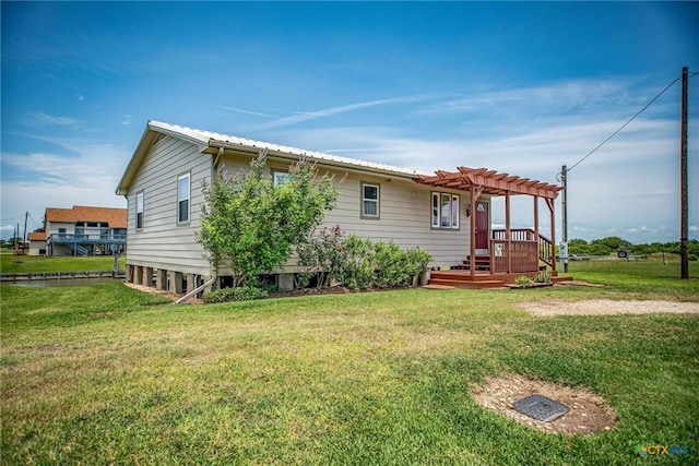 40 Sailfish Lndg, Port Lavaca, TX 77979 - rear view of property featuring a pergola, a yard, a metal roof, and a wooden deck