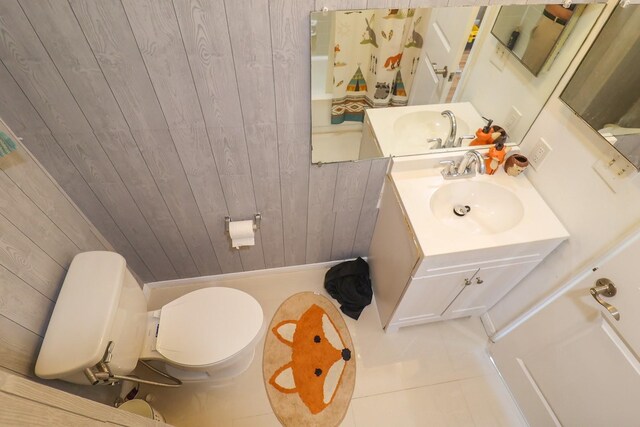 7264 Regency Square Ct, Houston, TX 77036 - full bathroom featuring tile patterned flooring, wooden walls, and vanity