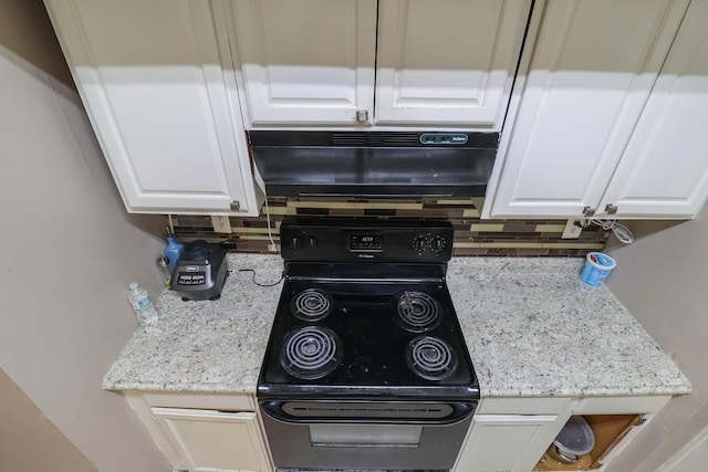7264 Regency Square Ct, Houston, TX 77036 - kitchen with black range with electric cooktop, white cabinets, tasteful backsplash, and light stone countertops