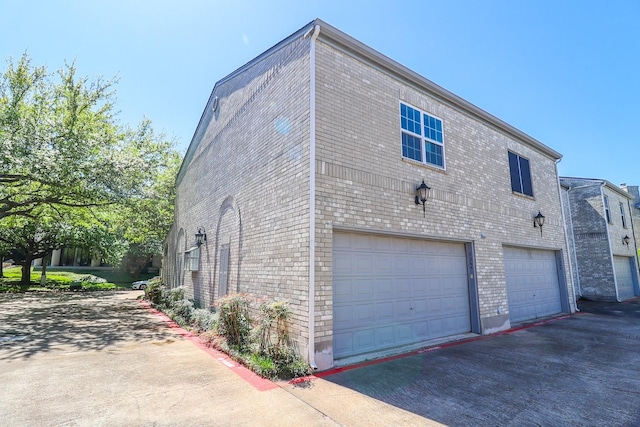 7264 Regency Square Ct, Houston, TX 77036 - view of property exterior with a garage, asphalt driveway, and brick siding