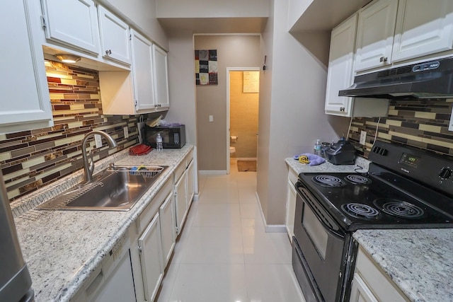 7264 Regency Square Ct, Houston, TX 77036 - kitchen with black appliances, under cabinet range hood, backsplash, and white cabinetry