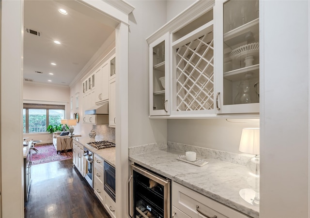 326 W 24th St, Houston, TX 77008 - indoor dry bar featuring wine cooler, appliances with stainless steel finishes, ornamental molding, under cabinet range hood, and dark wood-style flooring