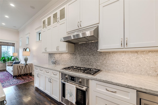 326 W 24th St, Houston, TX 77008 - kitchen featuring under cabinet range hood, appliances with stainless steel finishes, crown molding, dark wood finished floors, and white cabinetry