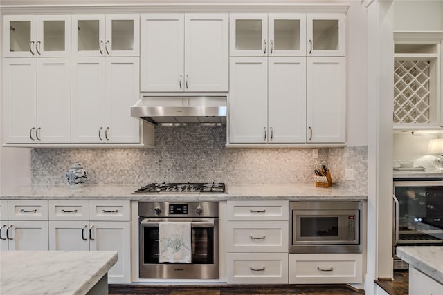 326 W 24th St, Houston, TX 77008 - kitchen featuring appliances with stainless steel finishes, beverage cooler, under cabinet range hood, and white cabinets