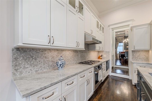 326 W 24th St, Houston, TX 77008 - kitchen with under cabinet range hood, appliances with stainless steel finishes, light stone countertops, white cabinetry, and dark wood-style floors
