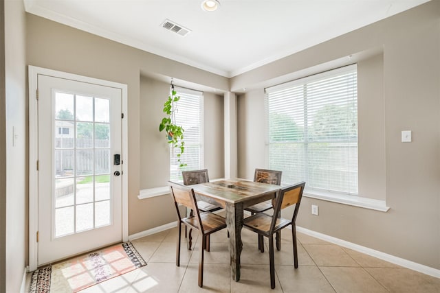 3817 Dunlavy Dr, Pearland, TX 77581 - dining space with healthy amount of natural light, ornamental molding, light tile patterned floors, and recessed lighting