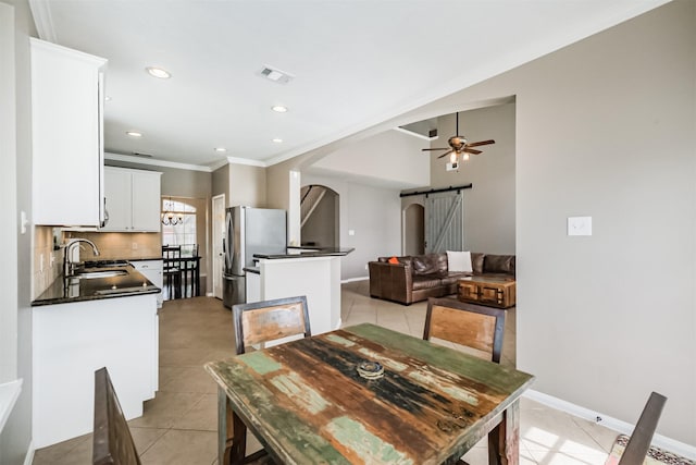 3817 Dunlavy Dr, Pearland, TX 77581 - dining space featuring a barn door, light tile patterned floors, crown molding, a ceiling fan, and recessed lighting