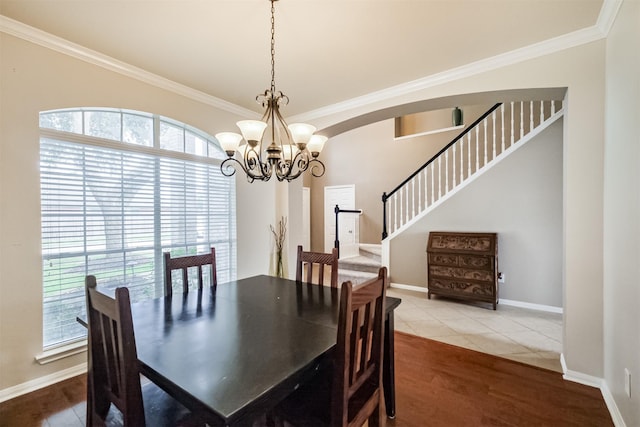 3817 Dunlavy Dr, Pearland, TX 77581 - dining area with ornamental molding, a chandelier, stairway, wood finished floors, and arched walkways