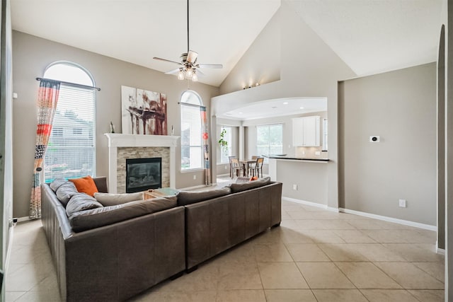 3817 Dunlavy Dr, Pearland, TX 77581 - living room with ceiling fan, vaulted ceiling, light tile patterned floors, and a fireplace