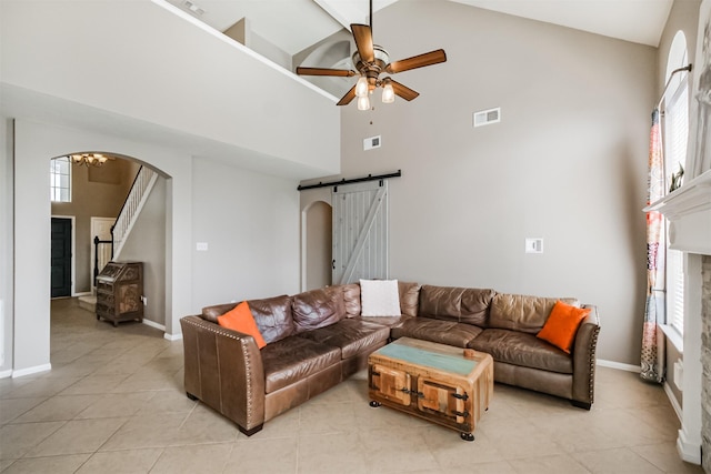 3817 Dunlavy Dr, Pearland, TX 77581 - living area featuring a barn door, high vaulted ceiling, arched walkways, stairs, and ceiling fan