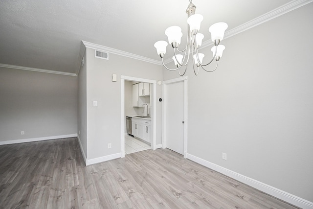 9707 Richmond Ave Unit 3, Houston, TX 77042 - empty room with ornamental molding, a chandelier, and light wood-type flooring