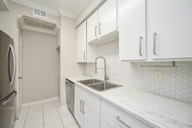 9707 Richmond Ave Unit 3, Houston, TX 77042 - kitchen featuring appliances with stainless steel finishes, ornamental molding, decorative backsplash, white cabinetry, and light stone countertops