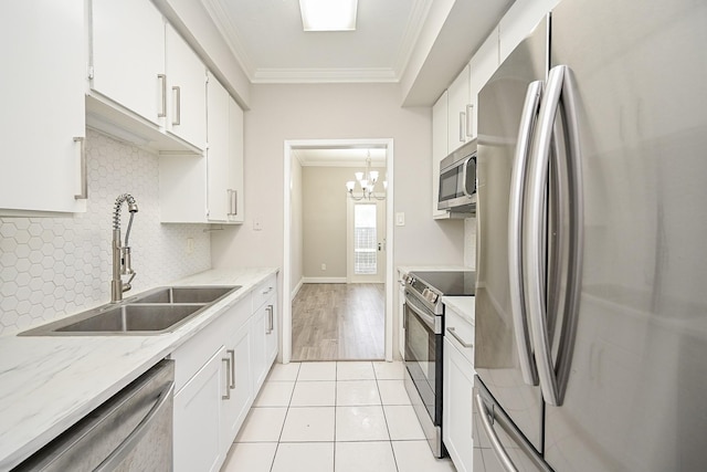 9707 Richmond Ave Unit 3, Houston, TX 77042 - kitchen featuring stainless steel appliances, crown molding, white cabinetry, and tasteful backsplash