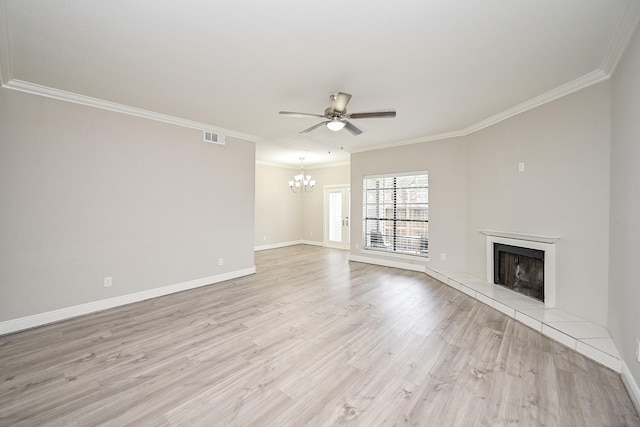 9707 Richmond Ave Unit 3, Houston, TX 77042 - unfurnished living room featuring a tile fireplace, ceiling fan, a chandelier, crown molding, and light wood finished floors