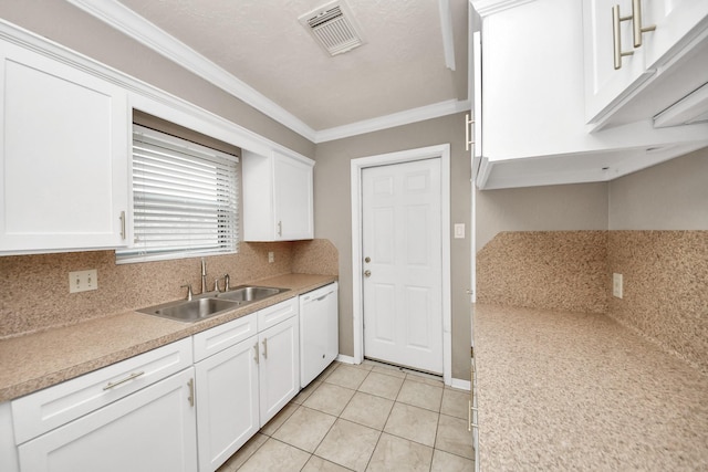 3938 Danpree St, Pasadena, TX 77504 - kitchen featuring white dishwasher, ornamental molding, white cabinets, backsplash, and light countertops