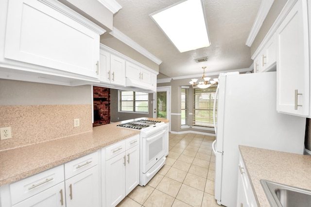 3938 Danpree St, Pasadena, TX 77504 - kitchen featuring white appliances, ornamental molding, a chandelier, light tile patterned flooring, and white cabinetry
