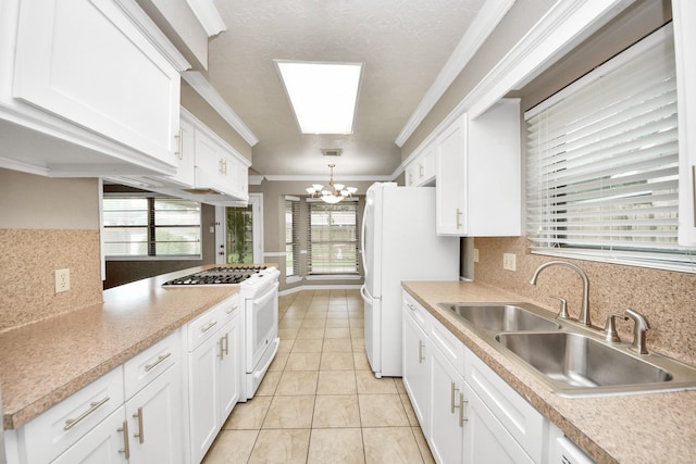 3938 Danpree St, Pasadena, TX 77504 - kitchen with white appliances, a chandelier, crown molding, white cabinets, and backsplash