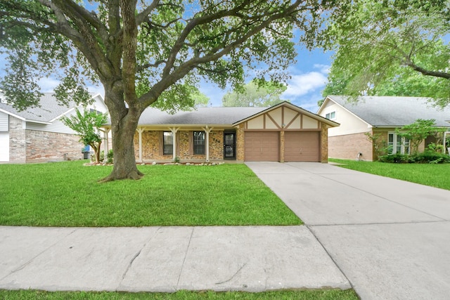 3938 Danpree St, Pasadena, TX 77504 - view of front of house featuring an attached garage, a front lawn, driveway, and brick siding