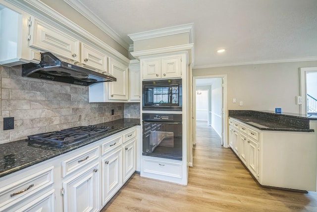 18318 Widcombe Dr, Houston, TX 77084 - kitchen featuring black appliances, under cabinet range hood, crown molding, dark stone counters, and light wood finished floors