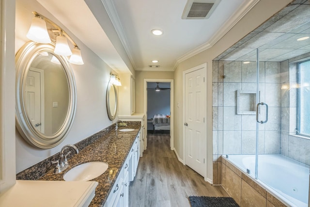18318 Widcombe Dr, Houston, TX 77084 - full bath with double vanity, connected bathroom, wood finished floors, recessed lighting, and crown molding