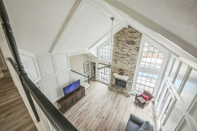 18318 Widcombe Dr, Houston, TX 77084 - living room with wood finished floors, beamed ceiling, and high vaulted ceiling