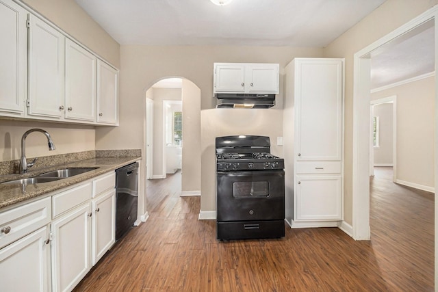 5235 Kingsbury St, Houston, TX 77021 - kitchen featuring black gas stove, under cabinet range hood, stainless steel dishwasher, arched walkways, and dark wood-type flooring