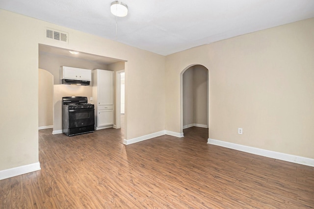 5235 Kingsbury St, Houston, TX 77021 - spare room featuring arched walkways and wood finished floors