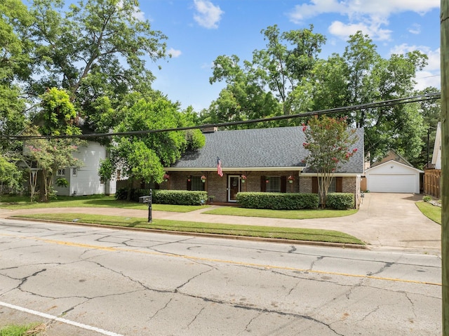 907 E Houston Ave, Crockett, TX 75835 - view of front facade with brick siding, a front lawn, a garage, and roof with shingles