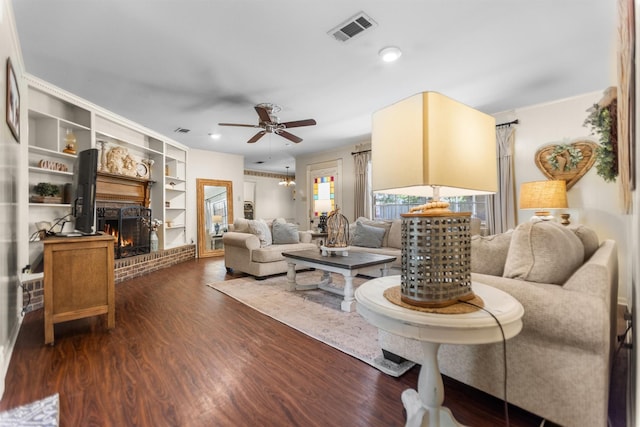 907 E Houston Ave, Crockett, TX 75835 - living room with ceiling fan, dark wood finished floors, a fireplace, built in features, and recessed lighting