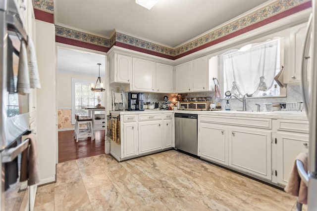 907 E Houston Ave, Crockett, TX 75835 - kitchen with appliances with stainless steel finishes, crown molding, white cabinetry, light countertops, and tasteful backsplash