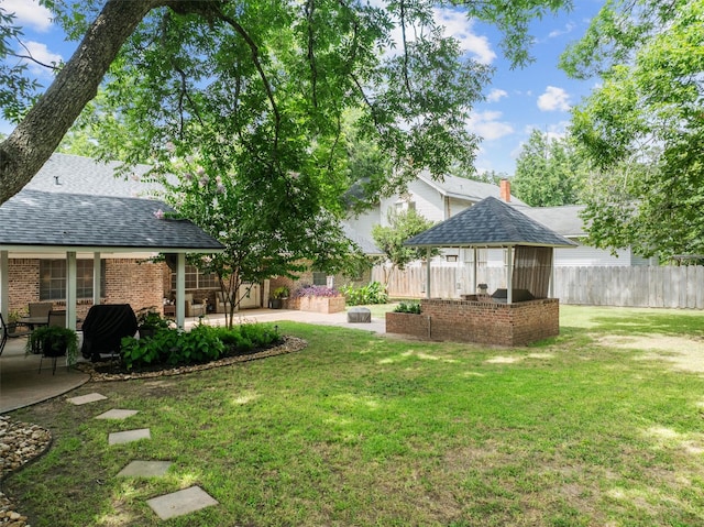 907 E Houston Ave, Crockett, TX 75835 - fenced backyard with a patio area and a gazebo