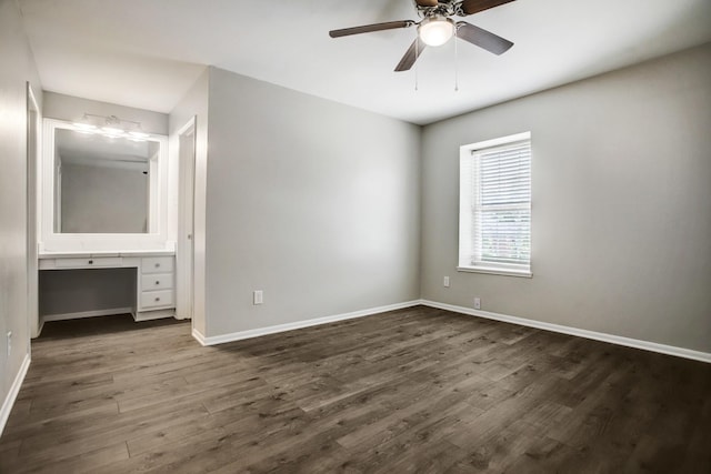 353 N Post Oak Ln Unit 819, Houston, TX 77024 - unfurnished bedroom featuring dark wood-type flooring, built in desk, and ceiling fan