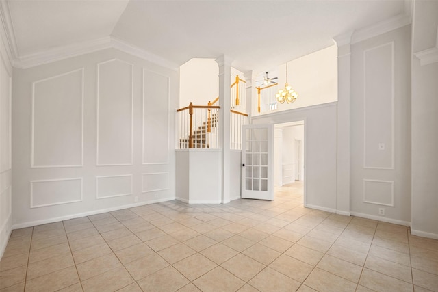 107 N Sunny Slope Cir, The Woodlands, TX 77381 - unfurnished room featuring a decorative wall, a chandelier, light tile patterned floors, crown molding, and stairway