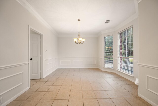 107 N Sunny Slope Cir, The Woodlands, TX 77381 - unfurnished room featuring crown molding, a chandelier, a decorative wall, light tile patterned floors, and wainscoting