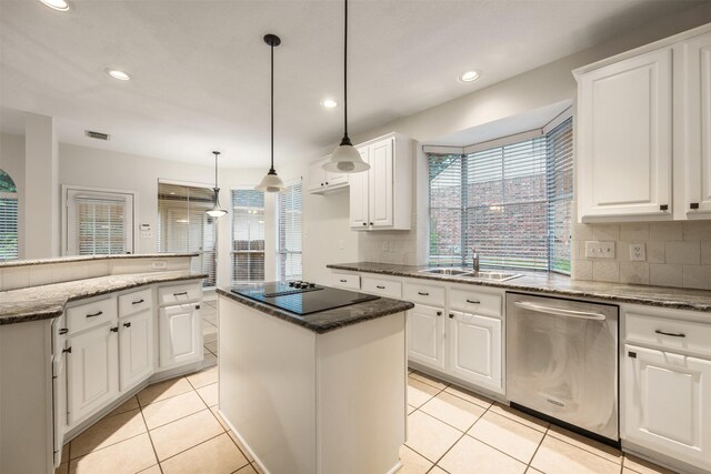107 N Sunny Slope Cir, The Woodlands, TX 77381 - kitchen featuring dishwasher, a center island, black electric cooktop, tasteful backsplash, and dark stone counters