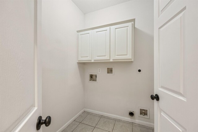 107 N Sunny Slope Cir, The Woodlands, TX 77381 - laundry area with hookup for an electric dryer, washer hookup, light tile patterned flooring, and cabinet space