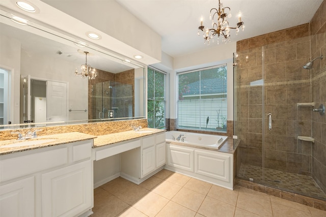 107 N Sunny Slope Cir, The Woodlands, TX 77381 - full bath featuring a chandelier, double vanity, a stall shower, a garden tub, and tile patterned floors