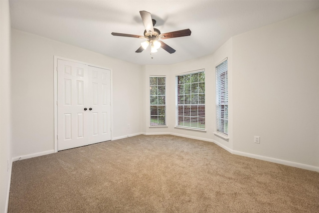 107 N Sunny Slope Cir, The Woodlands, TX 77381 - unfurnished bedroom with carpet floors, a ceiling fan, and a closet