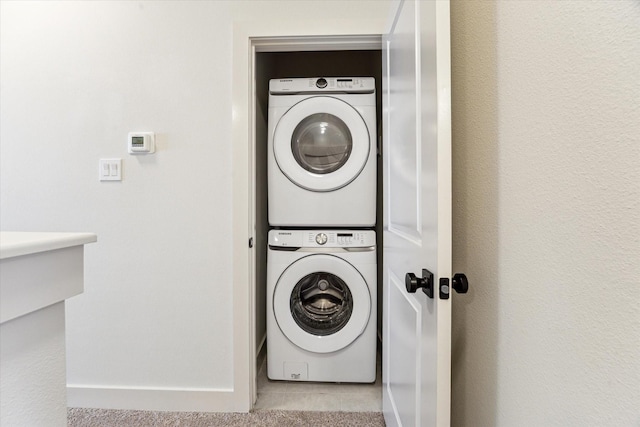 4155 Griggs Rd, Houston, TX 77021 - laundry room featuring stacked washer and clothes dryer and tile patterned flooring