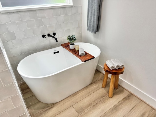 308 E 36th St, Houston, TX 77018 - bathroom featuring wood finished floors and a freestanding tub