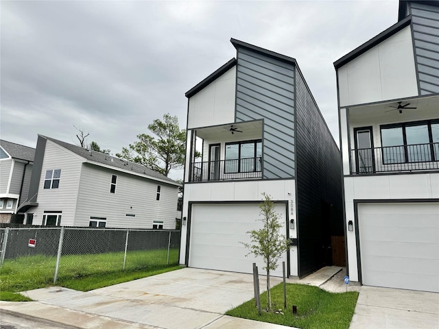 308 E 36th St, Houston, TX 77018 - contemporary home featuring a balcony, an attached garage, concrete driveway, and ceiling fan