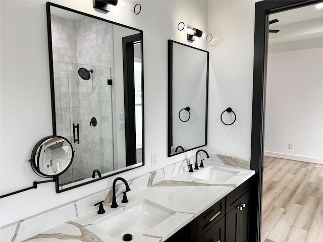 308 E 36th St, Houston, TX 77018 - full bath featuring double vanity, a stall shower, and wood finished floors