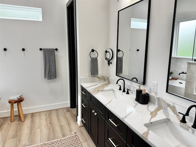 308 E 36th St, Houston, TX 77018 - bathroom featuring double vanity, plenty of natural light, and wood finished floors