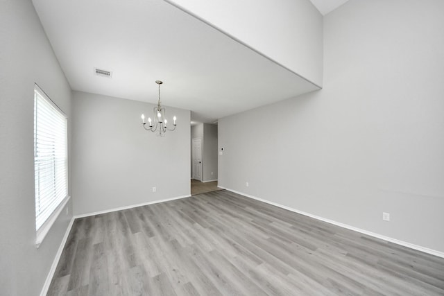 10342 Whisper Bluff Dr, Humble, TX 77396 - empty room with a chandelier and wood finished floors