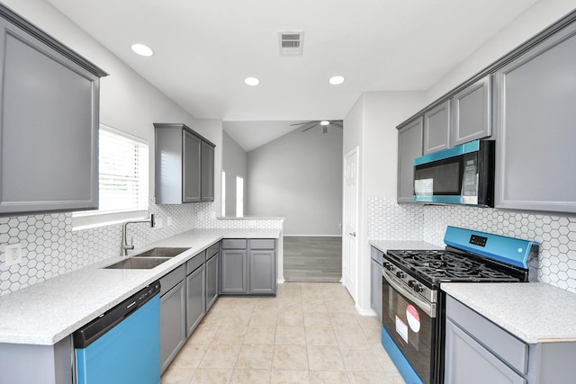 10342 Whisper Bluff Dr, Humble, TX 77396 - kitchen featuring stainless steel appliances, light countertops, gray cabinetry, recessed lighting, and lofted ceiling