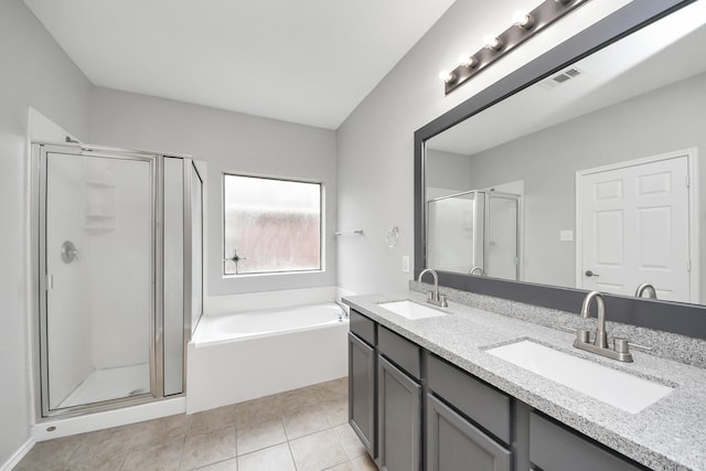 10342 Whisper Bluff Dr, Humble, TX 77396 - bathroom with a shower stall, a garden tub, double vanity, and tile patterned floors