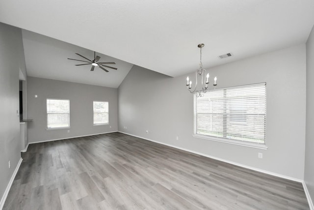 10342 Whisper Bluff Dr, Humble, TX 77396 - spare room featuring a chandelier, lofted ceiling, wood finished floors, and a ceiling fan