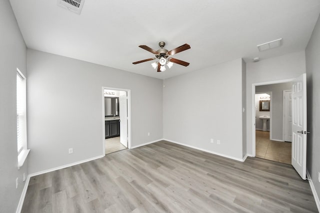 10342 Whisper Bluff Dr, Humble, TX 77396 - unfurnished bedroom featuring light wood-style flooring, ensuite bathroom, and a ceiling fan