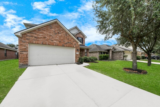 10342 Whisper Bluff Dr, Humble, TX 77396 - view of front of house featuring brick siding, an attached garage, driveway, and a front yard