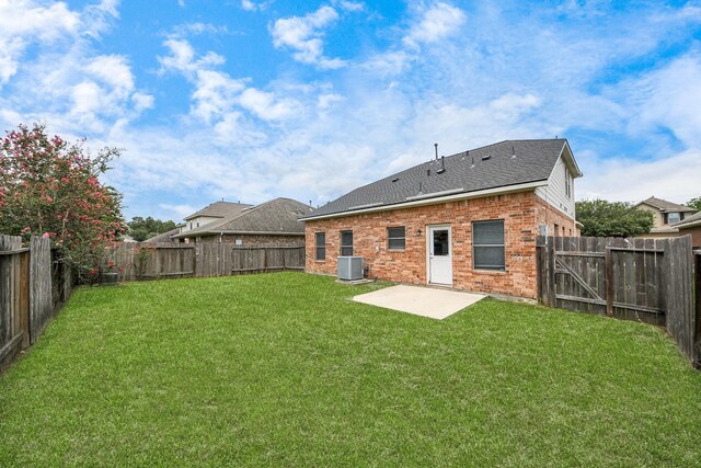 10342 Whisper Bluff Dr, Humble, TX 77396 - rear view of property featuring brick siding, a patio area, a fenced backyard, and a shingled roof
